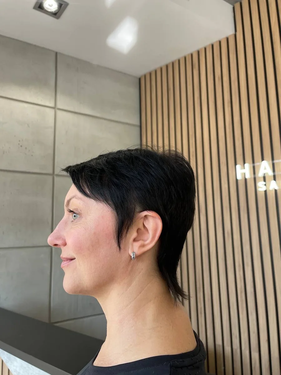 Bold jet-black pixie cut by Liza G.